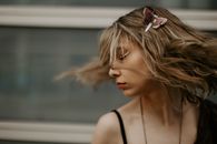 Woman in Black Tank Top With Pink Ribbon on Her Hair
