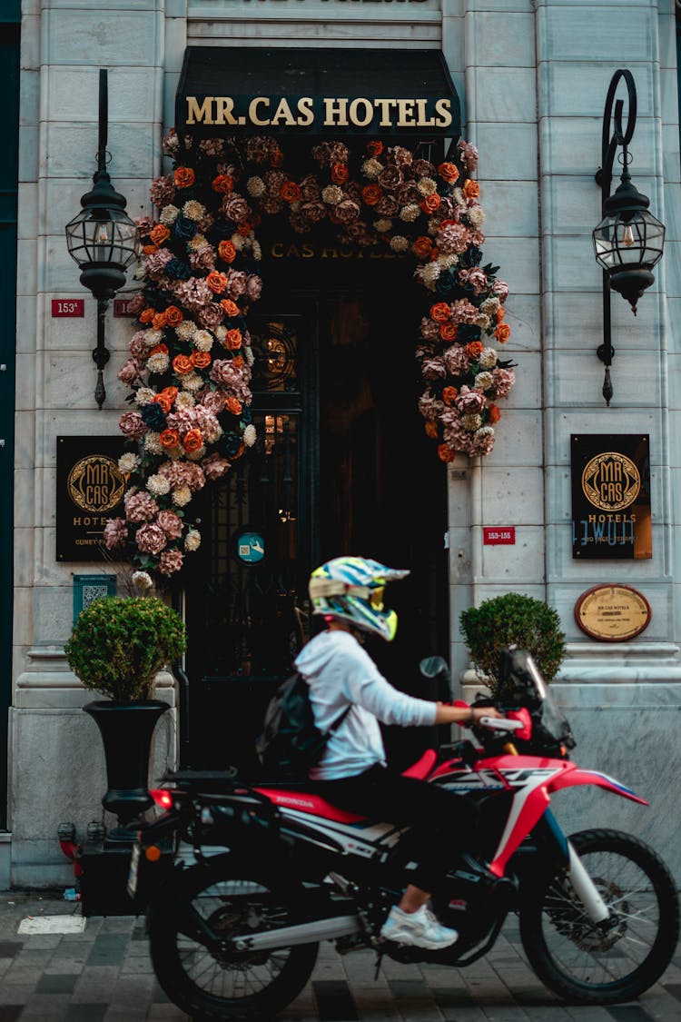 A Hotel Doorway With Floral Garland