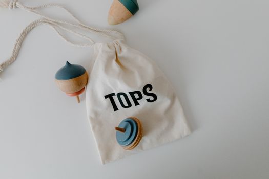 Photograph of Spinning Tops Near a Bag