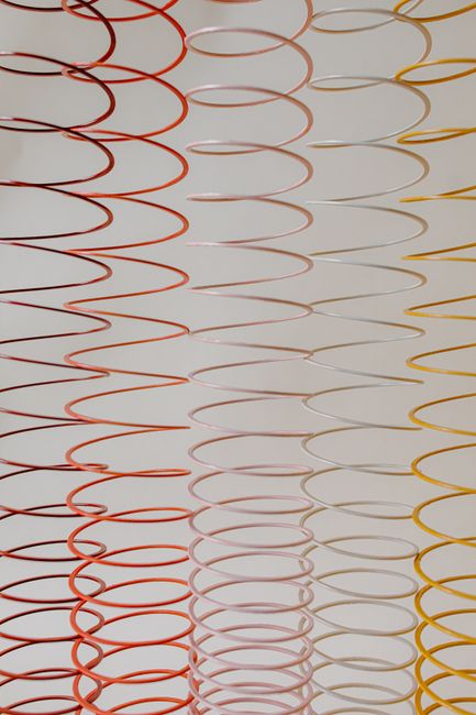 Colorful spiral patterns in red, pink, and yellow create a lively abstract backdrop.