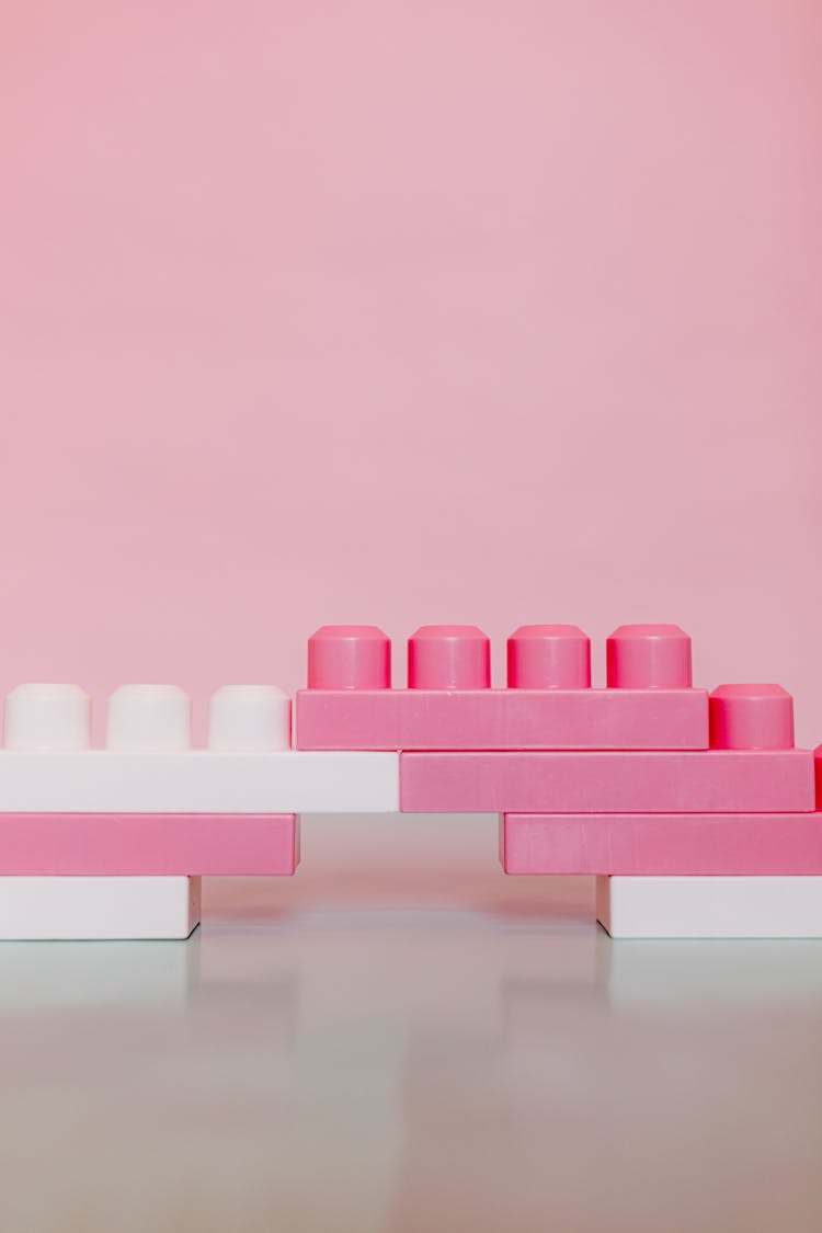 Pink And White Plastic Building Blocks Toy I Close-up Shot