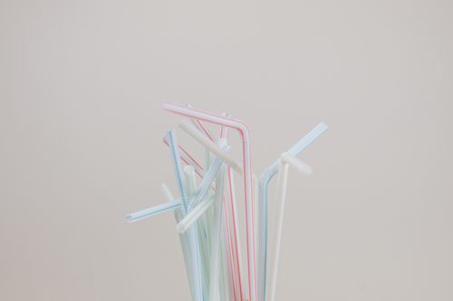 Free Aesthetic arrangement of colorful plastic straws on a neutral backdrop. Stock Photo
