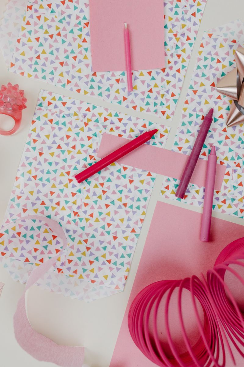 A vibrant, flat lay image showcasing arts and crafts supplies perfect for a party setting, with pastel colors and geometric patterns.