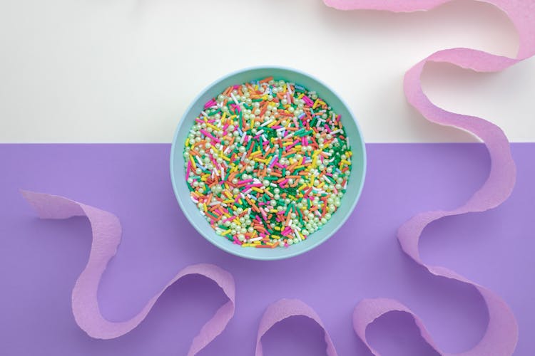 A Bowl Of Sweet Treats Surrounded By Purple Cut-Out Paper