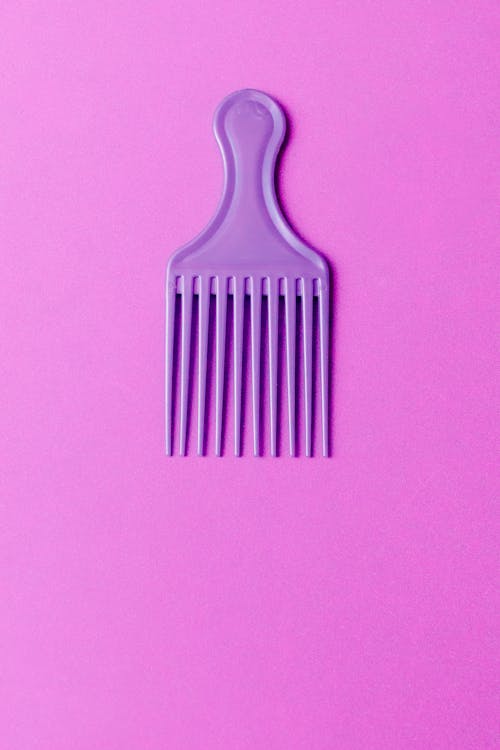 A Purple Hair Comb on Purple Surface