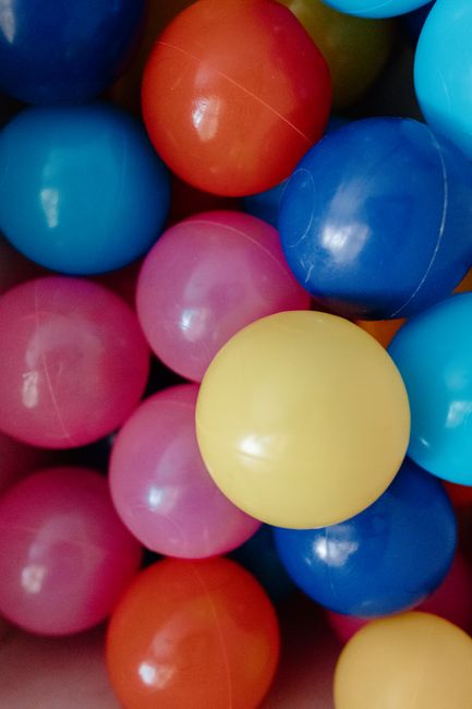 Vibrant close-up of colorful plastic balls in a ball pit.