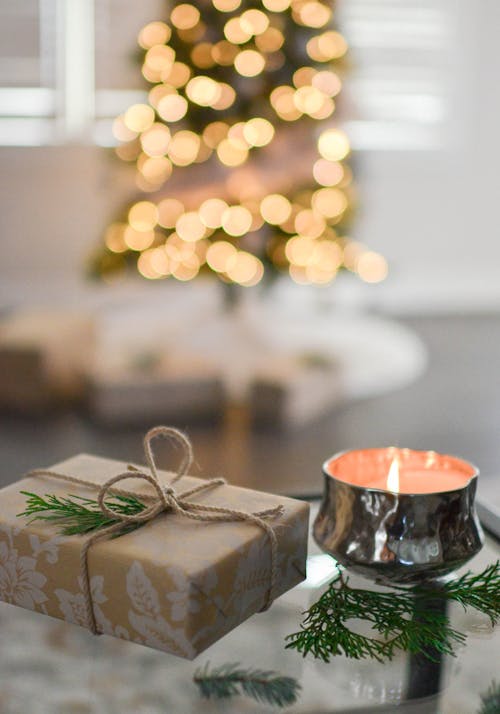 Free Close-Up Photography of Gift Besides Candle Stock Photo