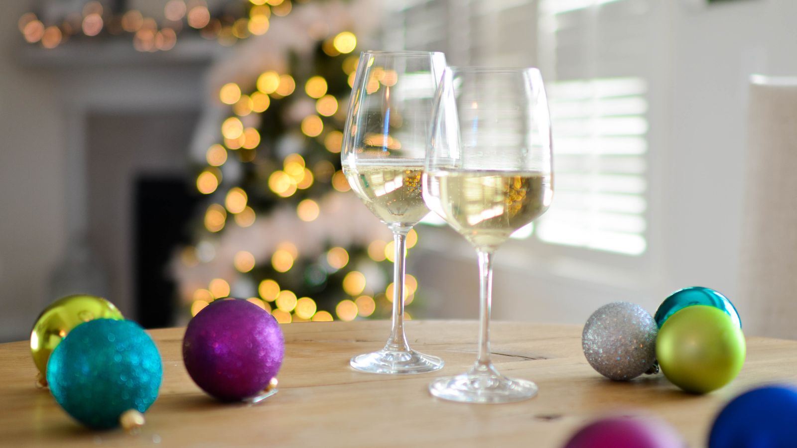 Two champagne glasses on a table set for a celebration