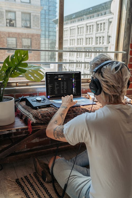 Free Person Wearing Headphones in Front of His Laptop Stock Photo