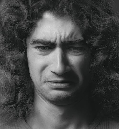 Grayscale Photo of Man with Curly Hair
