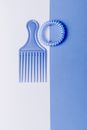 Blue Hair Comb and Spiral Hair Tie on Blue and White Surface