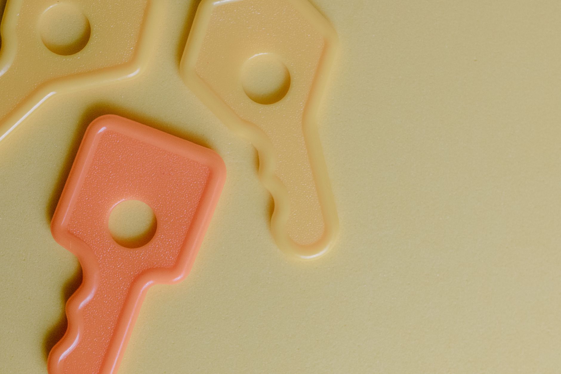 backup encryption key management explained: colorful plastic keys on a yellow surface