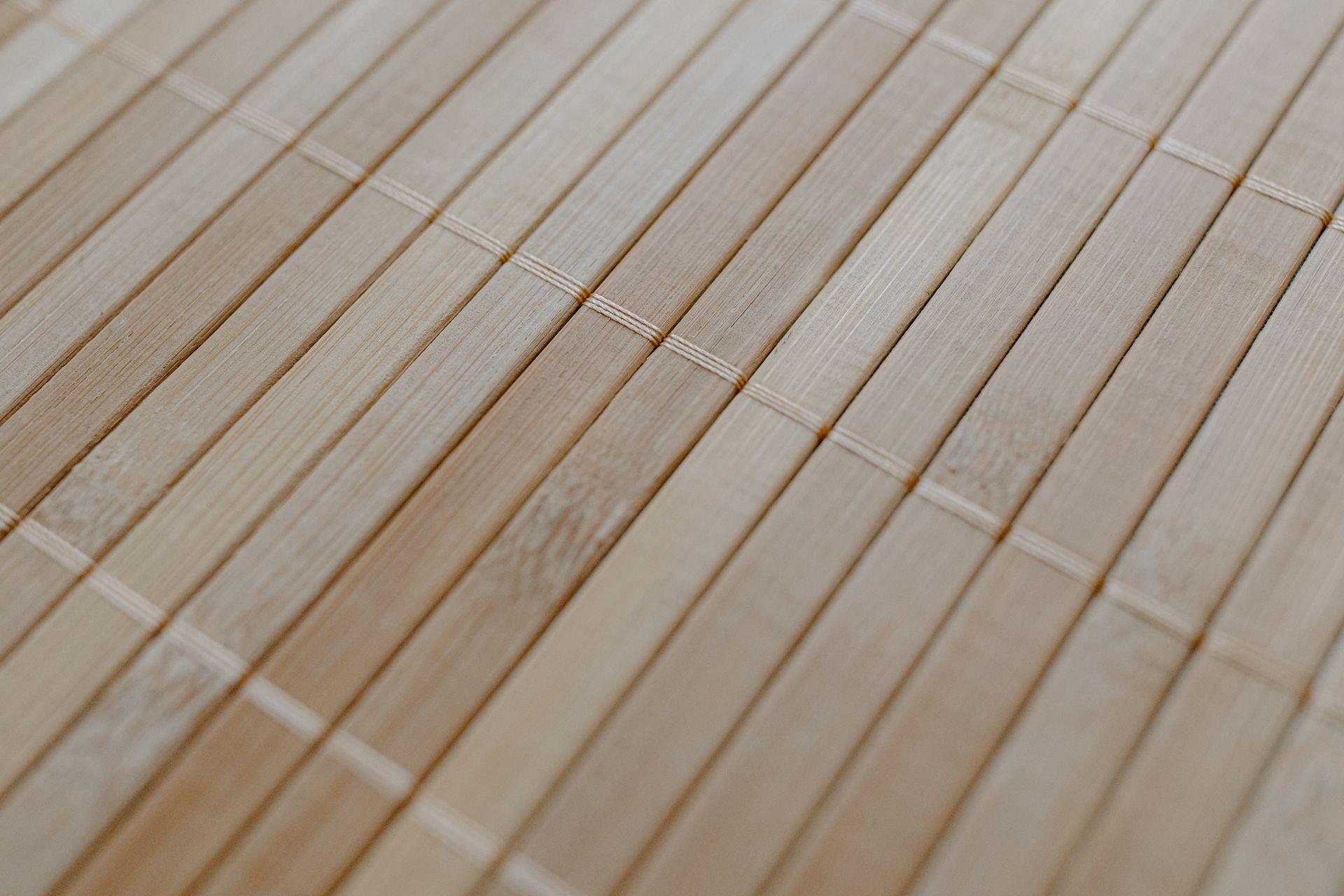 Detailed view of a bamboo mat showcasing its natural wood texture and minimalist design.