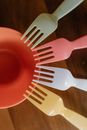 Red Plastic Fork on Brown Wooden Table