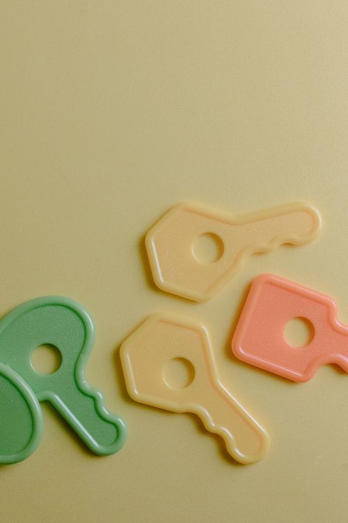 Plastic Keys Toy on Yellow Surface · Free Stock Photo