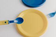 Blue Plastic Spoon on Yellow Round Plate