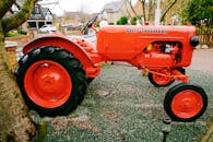 A Red Tractor on the Pebble-covered Ground
