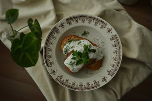 Free Toasted Bread with Cream on Top on a Ceramic Plate Stock Photo