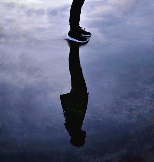 A Person Standing on Wet Surface