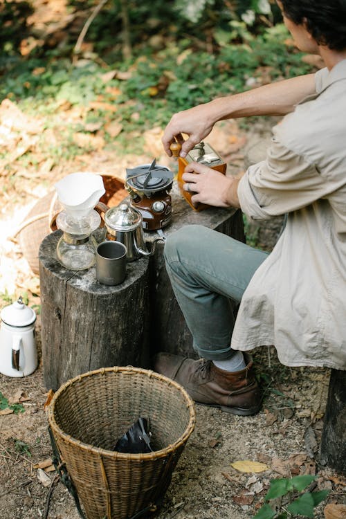 Free Crop farmer grinding coffee on stump in countryside Stock Photo