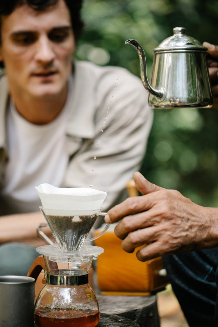 Crop Partners With Kettle Preparing Coffee In Garden