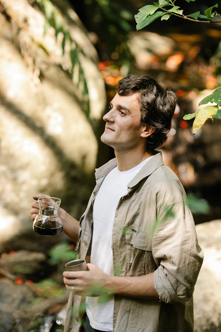 Dreamy Man With Coffee In Pitcher In Garden