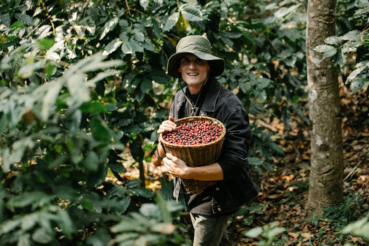 Cheerful Man With Coffee Beans In Woods