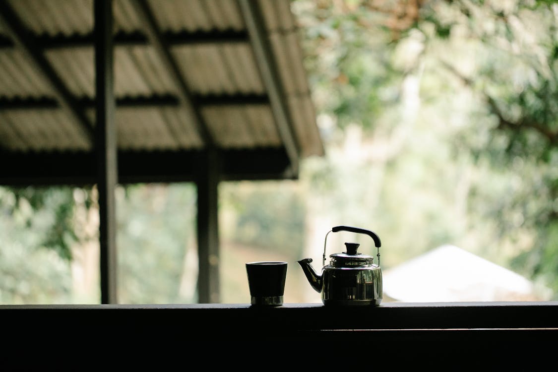 Free Kettle and glass of coffee on veranda Stock Photo