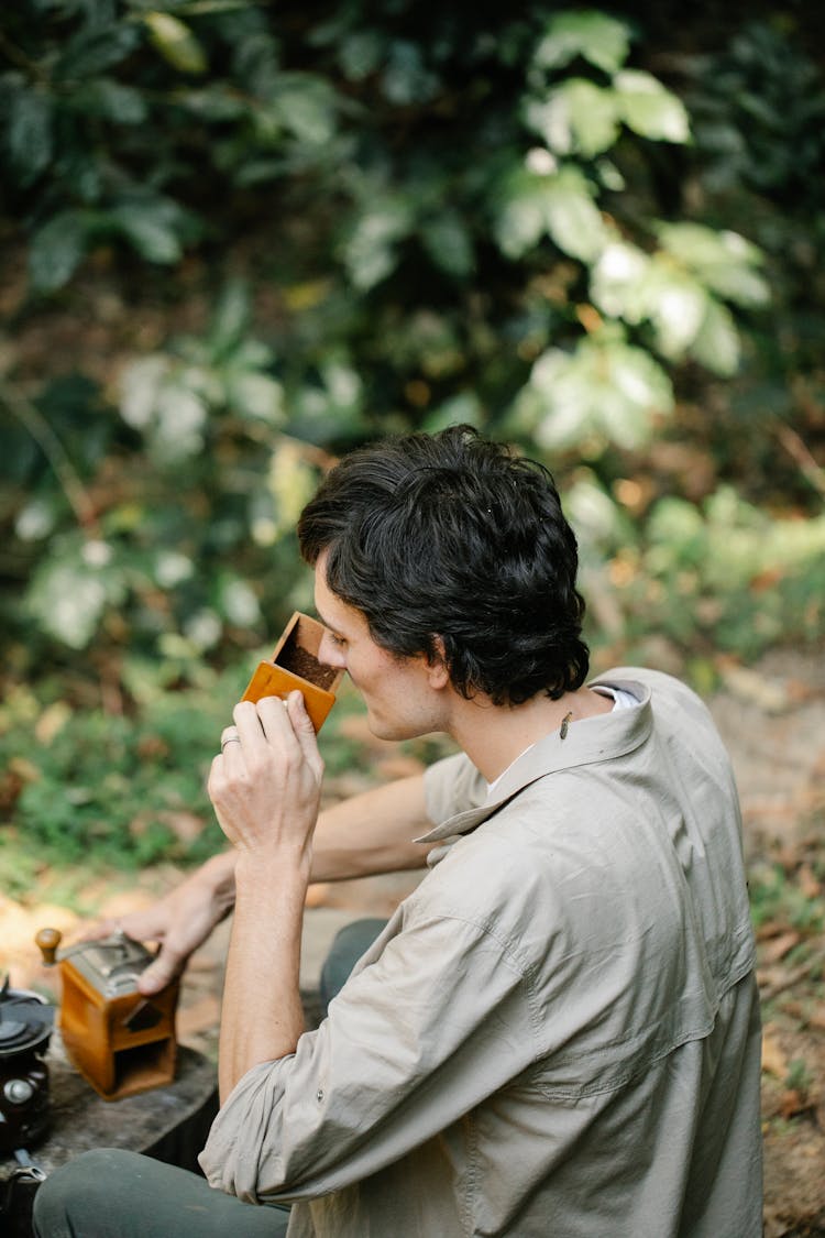 Man With Coffee Grinder In Nature