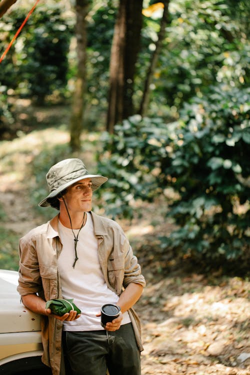 Content man with coffee in woods