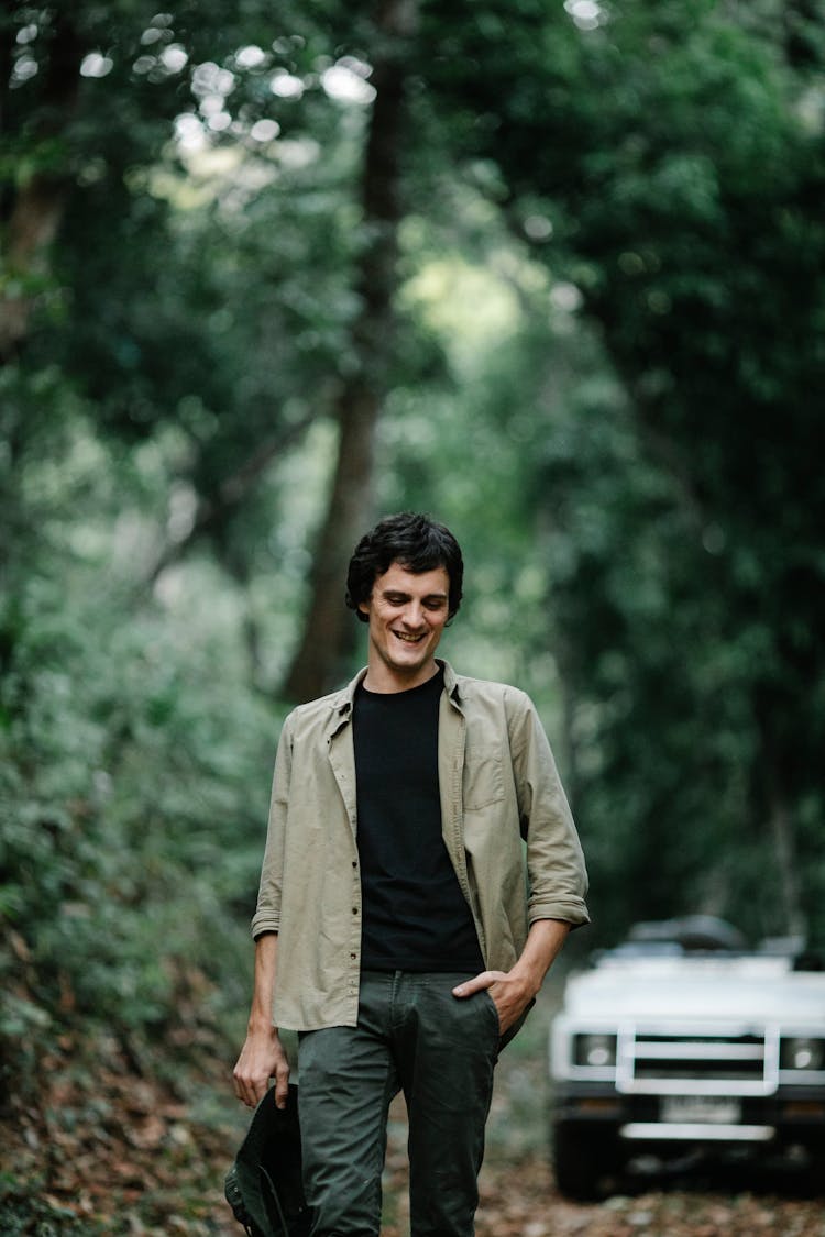 Happy Man Walking On Path In Forest