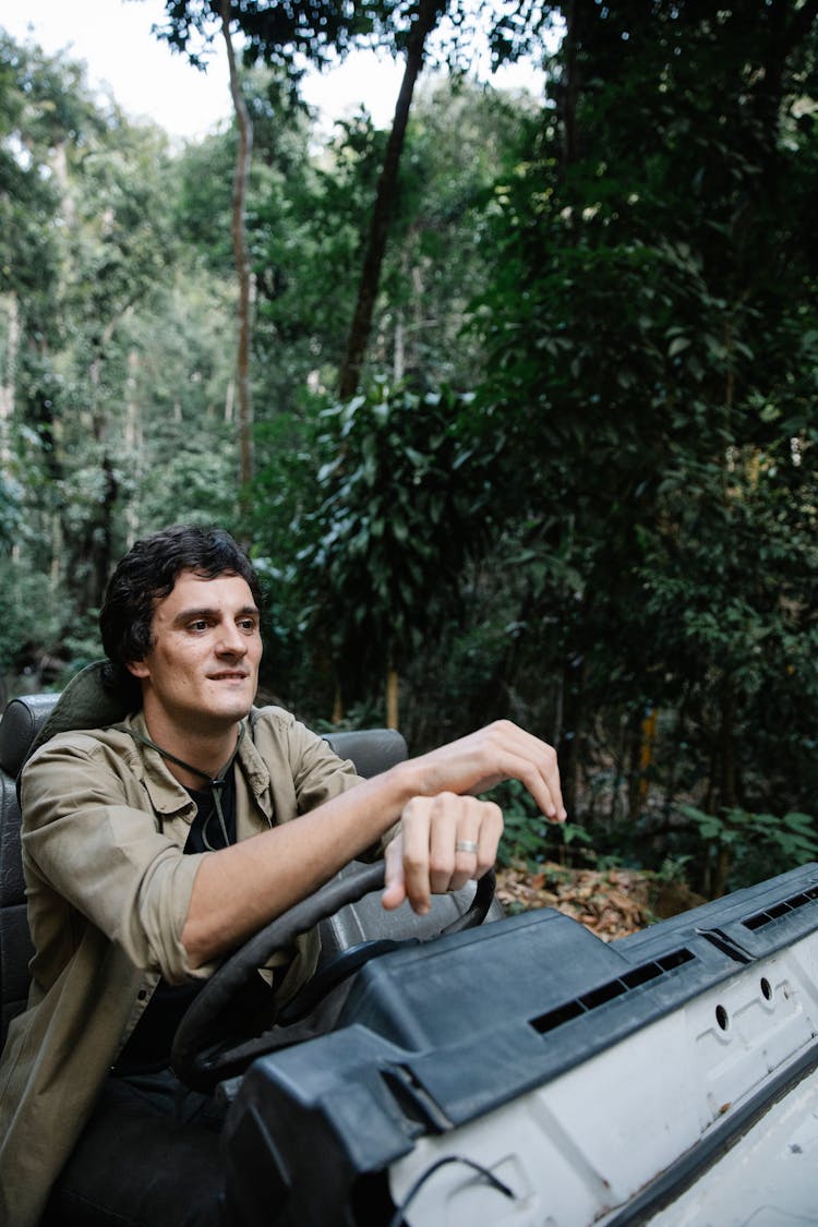 Man Driving Car In Woods