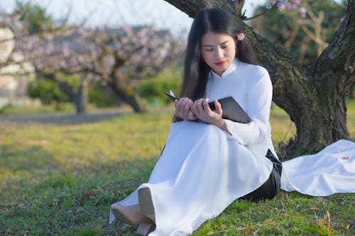 Asyalı, Beyaz elbise, çim içeren Ücretsiz stok fotoğraf