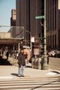 Man in Black Jacket Walking on Sidewalk