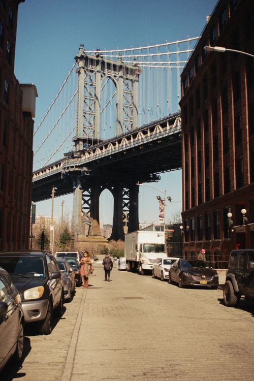 Free A street view of the Manhattan Bridge framed by buildings in Brooklyn, NYC. Stock Photo