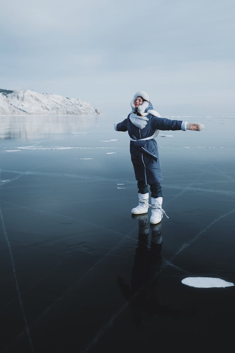 Woman Standing On A Frozen Lake