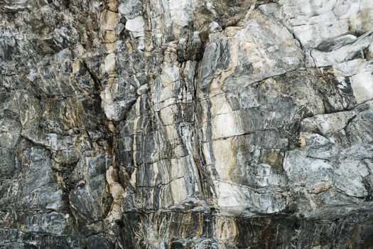 Detailed view of a natural granite cliff face showing texture and geological formations.