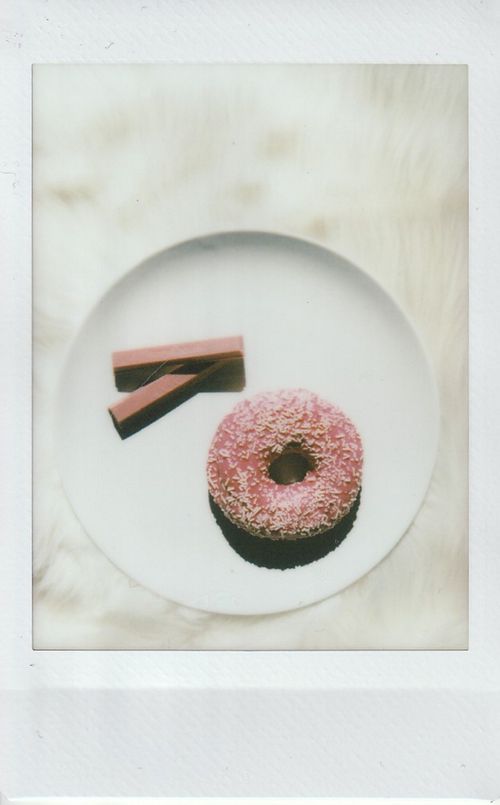 Free Top view of a pink donut and chocolate sticks on a white plate. Stock Photo