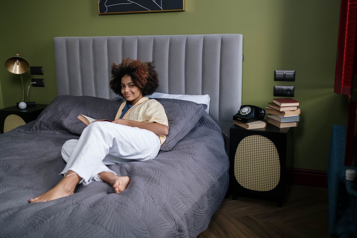 Natural Afro-textured hair resting against bedding — black hair breakage