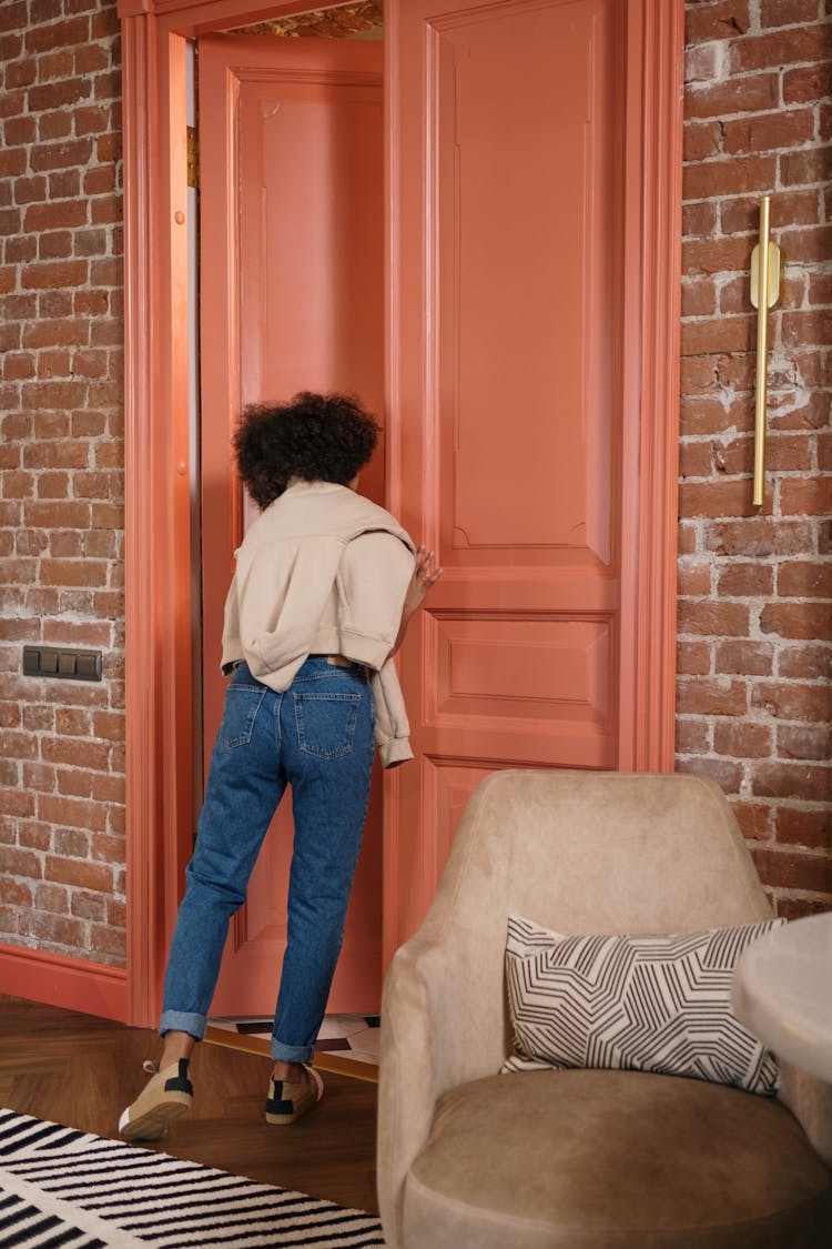 Photo Of A Woman Opening A Door