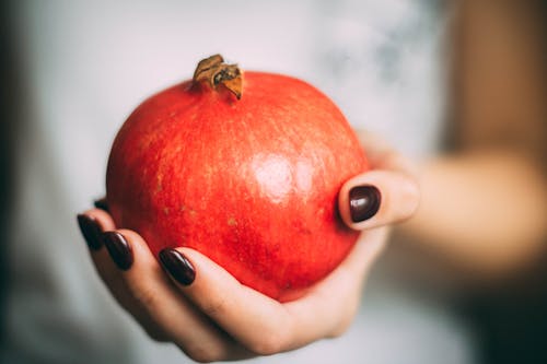 Free Red Pomegranate at Woman's Hand Stock Photo
