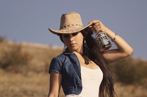 Free Woman in White Tank Top and Black Leather Jacket Holding Coca Cola Can Stock Photo