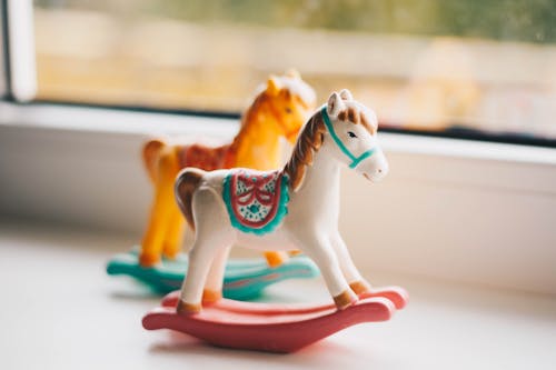 Free Small toy horses for kids on windowsill Stock Photo
