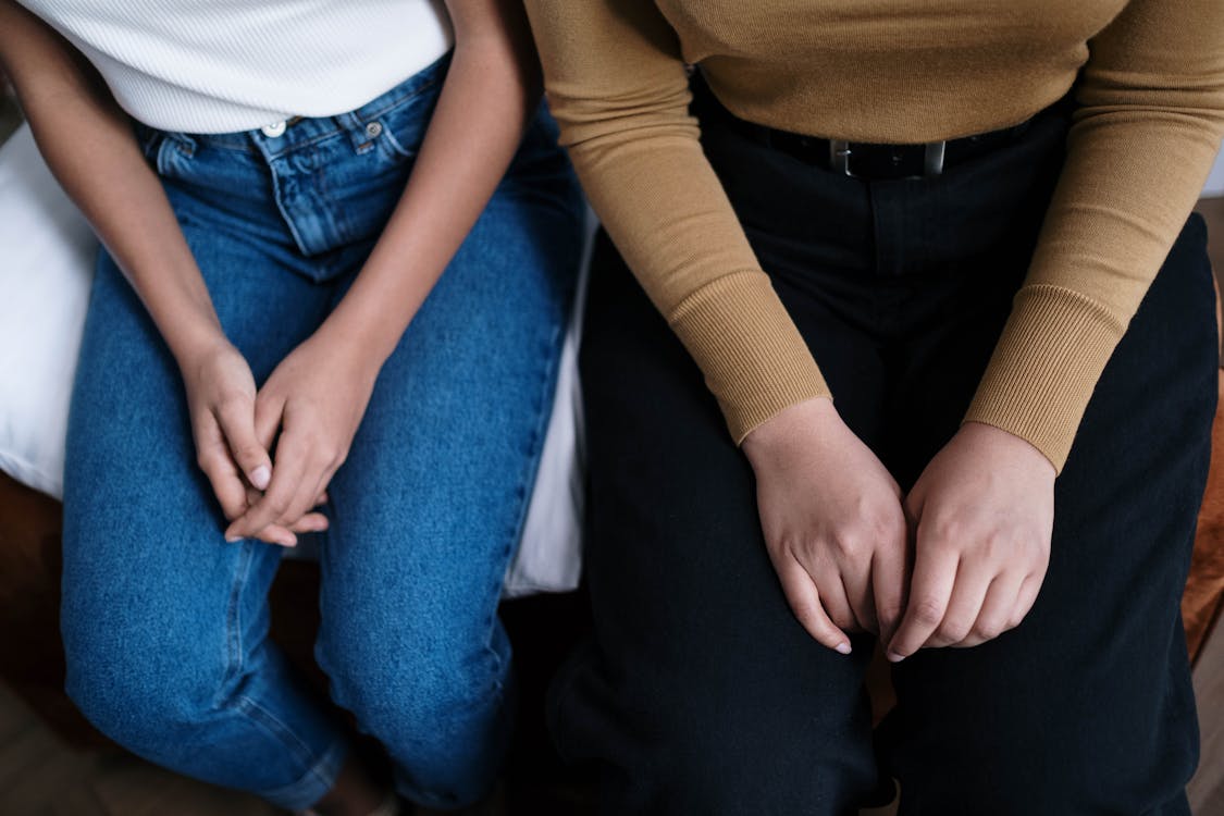 Woman in Brown Long Sleeve Shirt and Blue Denim Jeans