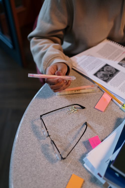 Person Holding a Pink Pen 