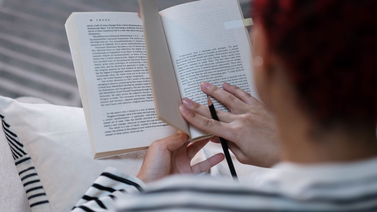 Reading as an offline screen time alternative Person reading a book as an offline alternative to unnecessary screen time