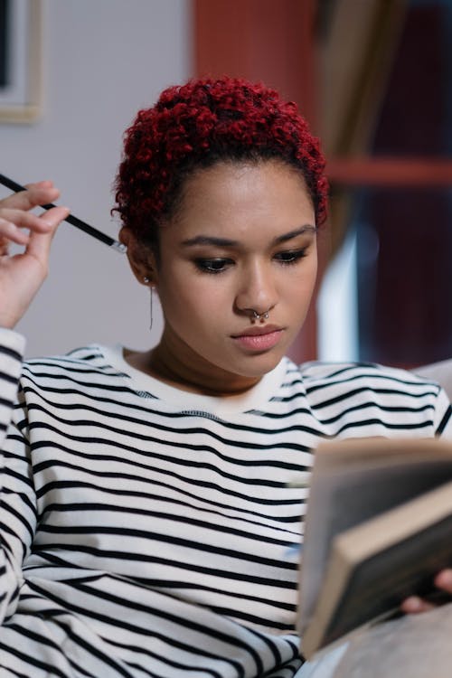 Portrait of a Woman with Red Hair Studying