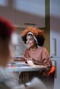 Woman in Brown Long Sleeve Shirt Sitting on Chair