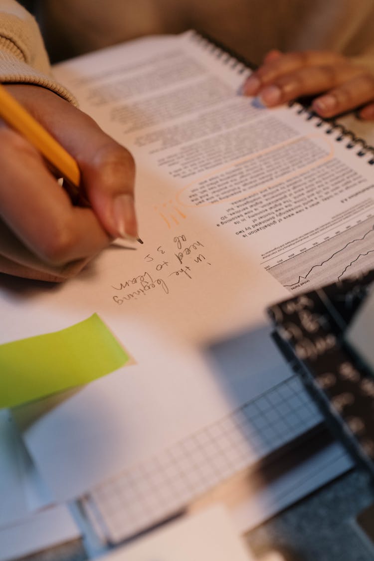 Person Writing On A Paper