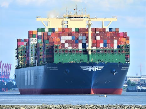 Front view of a massive cargo ship loaded with containers in Hamburg's harbor.